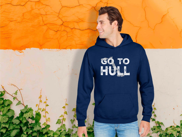 Man wearing a navy hoodie with 'GO TO HULL' text against an orange and beige wall.