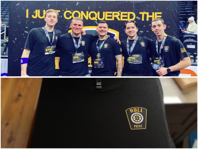 Five men in matching jerseys with medals, standing in front of a backdrop with 'I Just Conquered The' text. Below is a close-up of a black shirt with a gold logo.