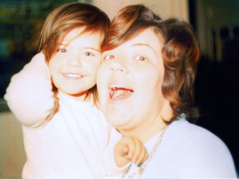 Two children posing for a photo with a blurred background
