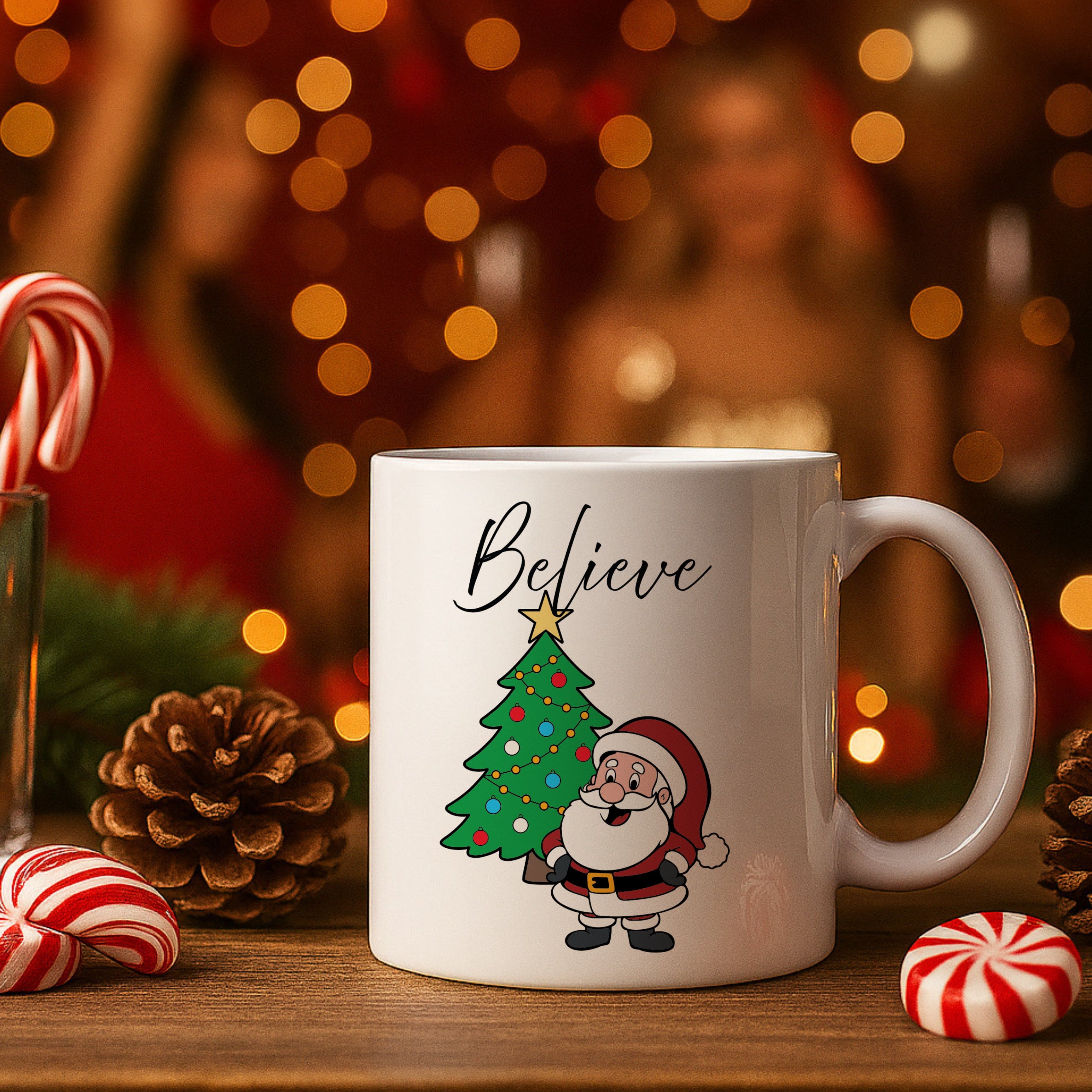 White mug with Santa Claus and Christmas tree design, surrounded by festive decorations on a wooden surface.