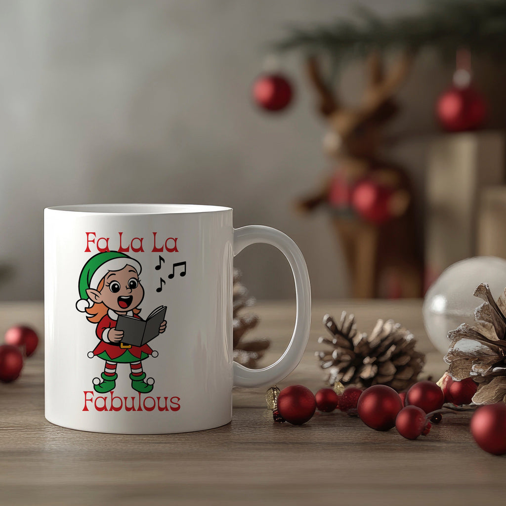 White mug with Christmas-themed design featuring an elf and text, placed on a table with festive decorations.