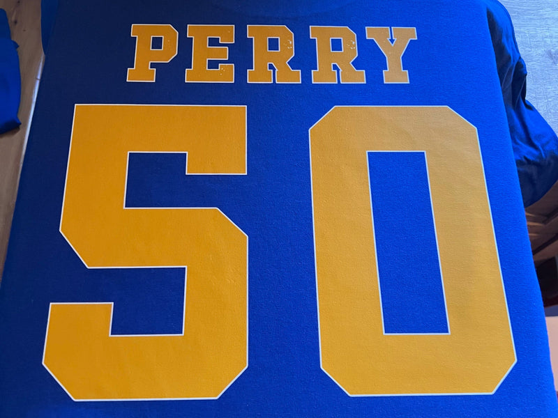 Blue jersey with 'PERRY' and number '50' in yellow on a blue background