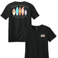 Black t-shirt with colorful surfboard design and text on a white background